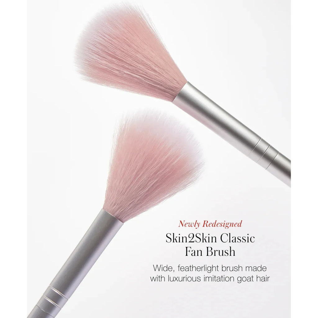 Two fan makeup brushes with soft bristles on a white background.