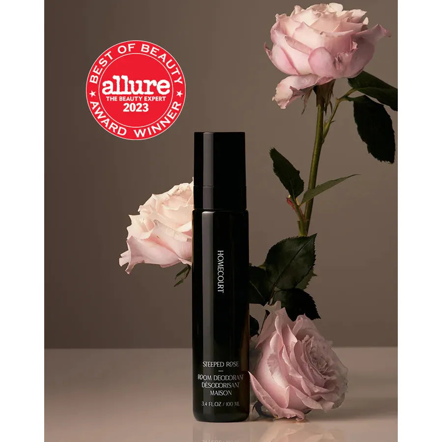 Bottle of rose room deodorizer with fresh roses and an allure best of beauty 2023 award seal.