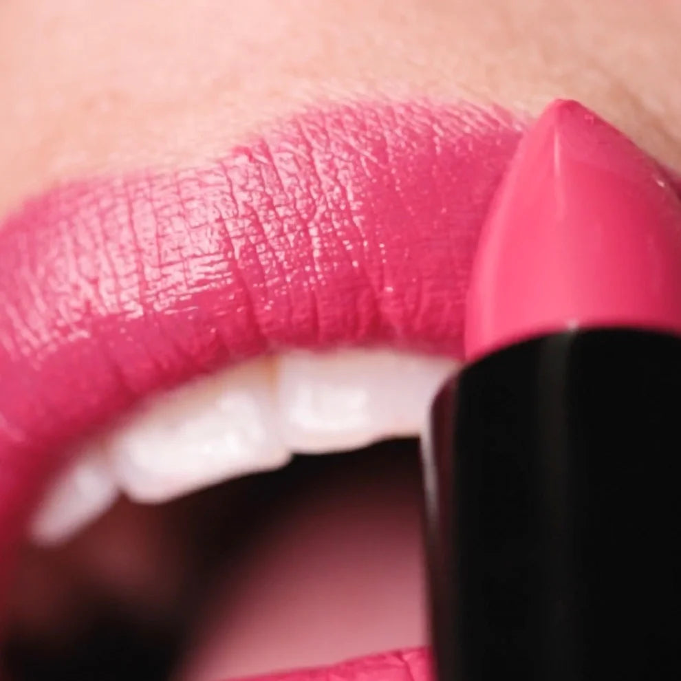 Close-up of pink lipstick being applied to lips.