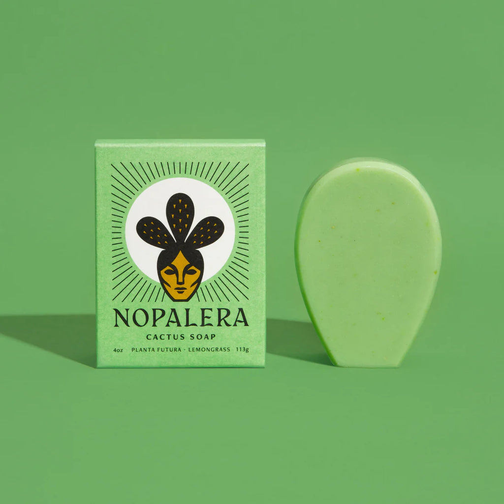 A bar of cactus soap alongside its packaging with the brand name 'nopalera' on a green background.
