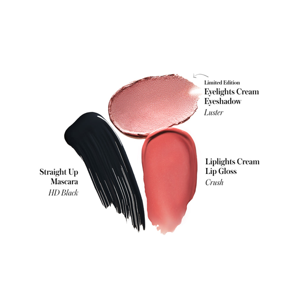 Swatches of makeup products: black mascara, pink cream eyeshadow, and coral cream lip gloss.