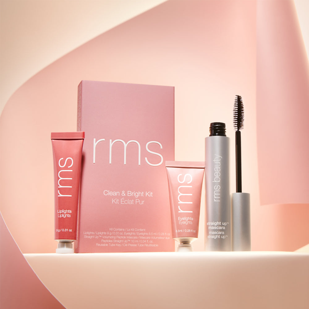 A curated collection of rms beauty makeup products displayed against a soft pink background.