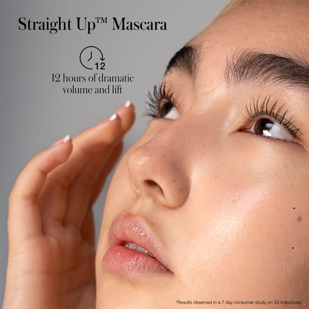 Close-up of a person showcasing eyelashes enhanced by straight upâ„¢ mascara, with a claim of 12 hours of volume and lift.