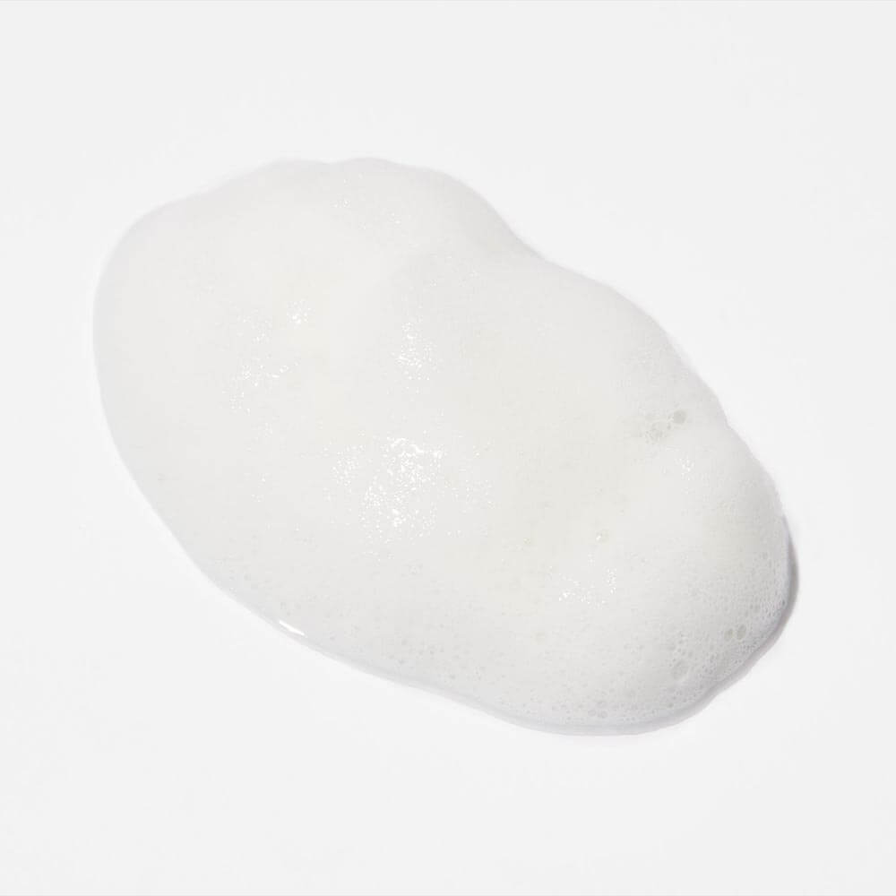 Dollop of white foam on a clean surface.