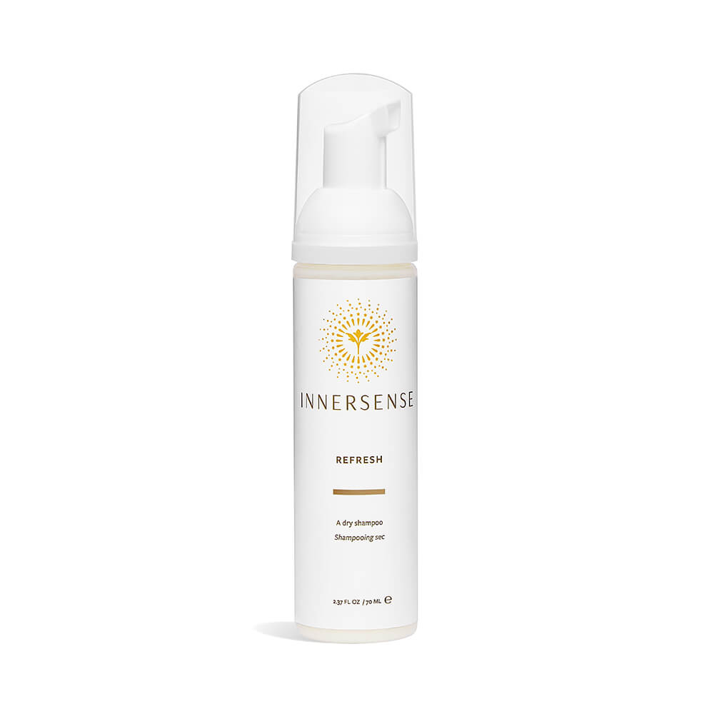 A bottle of innersense refresh dry shampoo on a white background.
