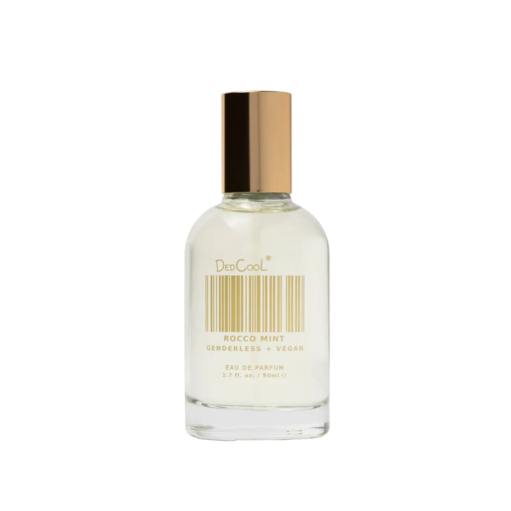 A clear glass bottle of dedcool rocco mint genderless vegan eau de parfum against a white background.