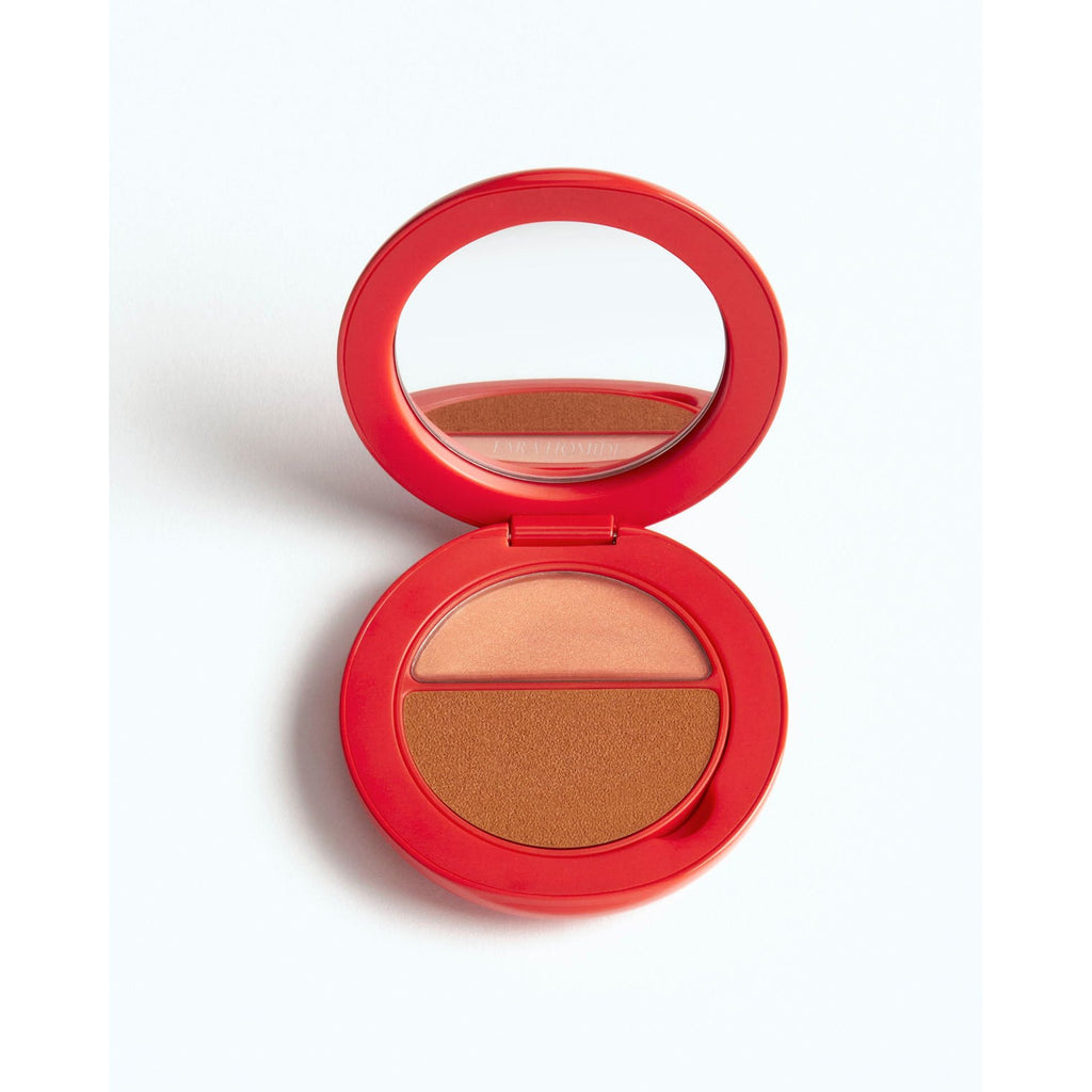 A compact powder with a mirror in an open red case.