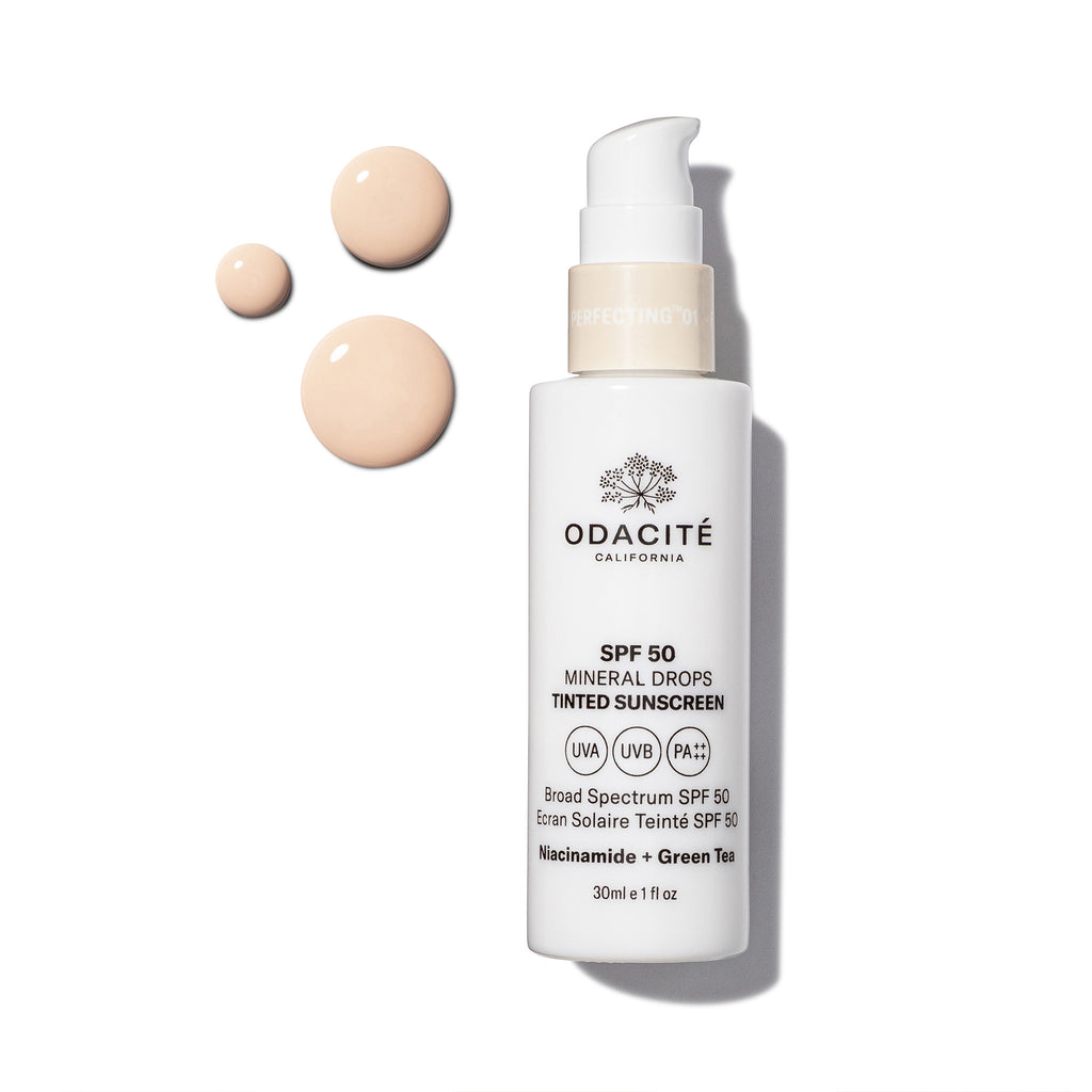 Cosmetic bottle with a pump labeled "odacite california perfecting drops spf 50 mineral tinted sunscreen" alongside small samples of the product on a white background.