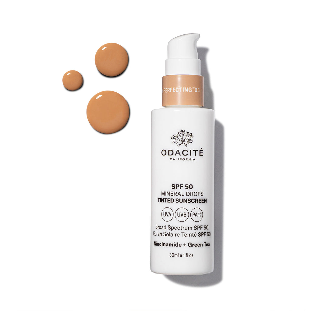 Bottle of odacite tinted mineral sunscreen with spf 50 alongside dollops of the product.