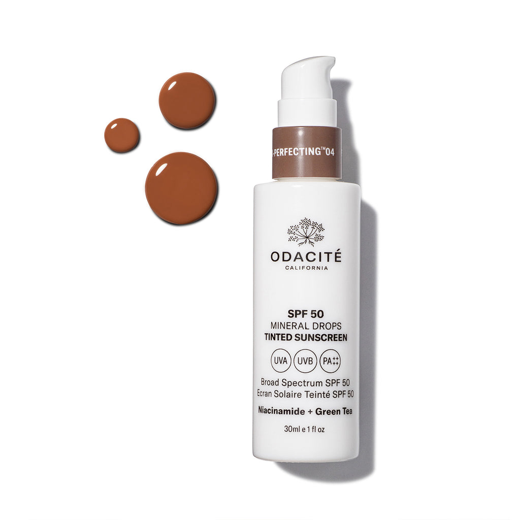 Bottle of odacite tinted sunscreen with spf 50 and product samples on a white background.