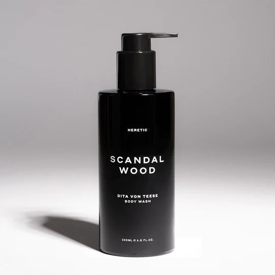 Black bottle of "scandal wood" body wash with pump dispenser.