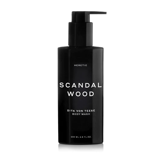Black bottle of "scandal wood" body wash by dita von teese with a pump dispenser, isolated on a white background.