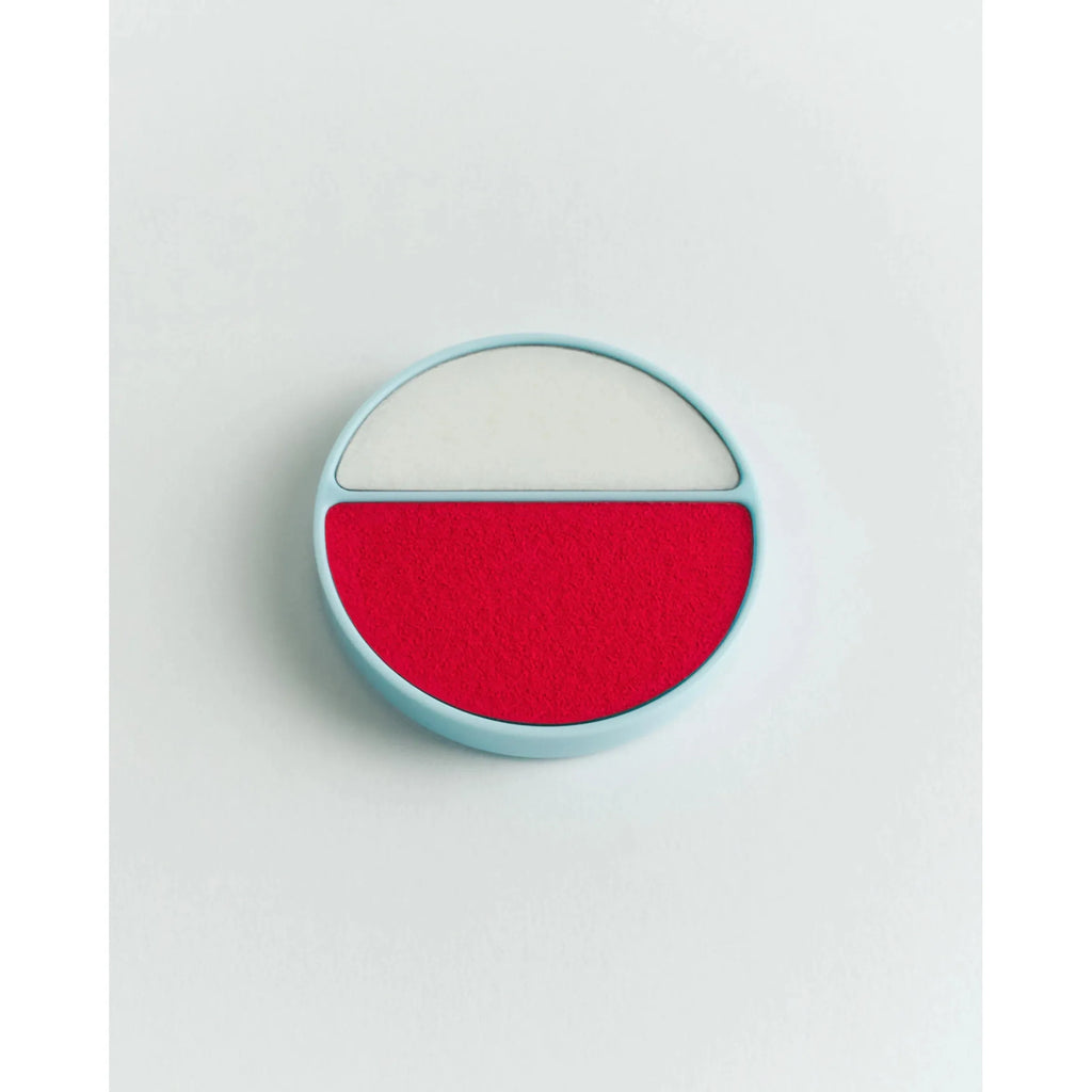 A pill with a blue casing and split color design, half white and half red.