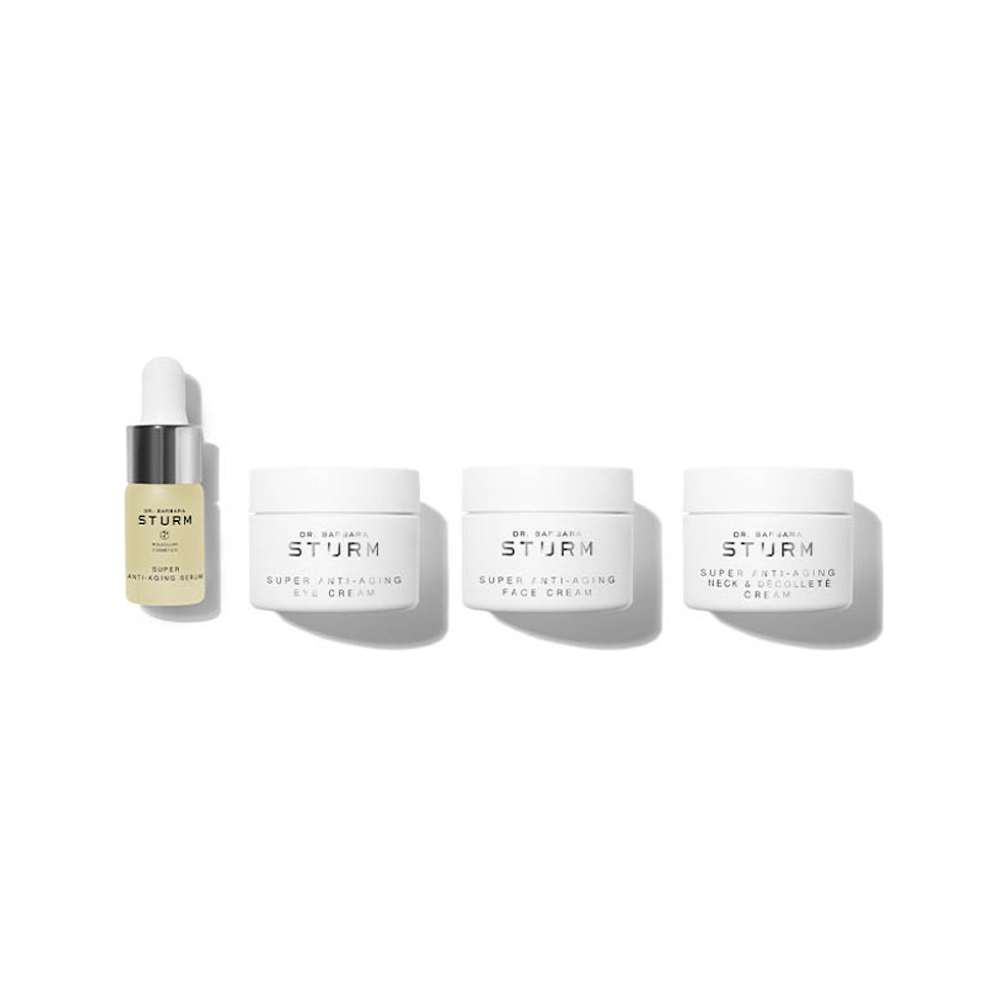 A collection of four dr. barbara sturm skincare products including a serum and three creams, isolated on a white background.