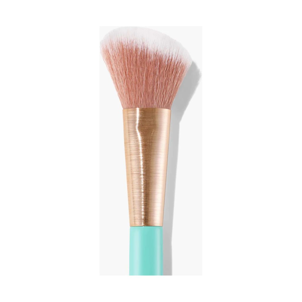 A cosmetic brush with a gold-tone ferrule and a teal handle on a white background.
