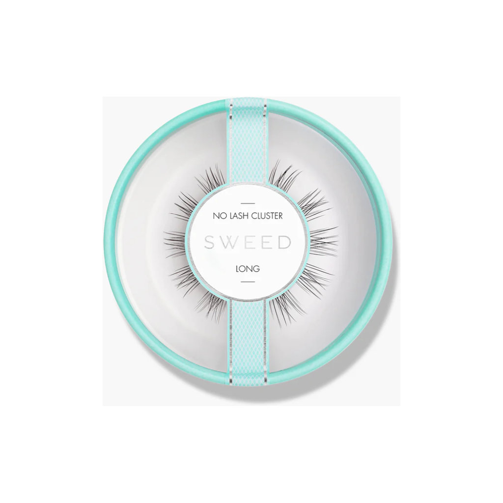 A set of long false eyelashes presented on a circular package resembling a plate.