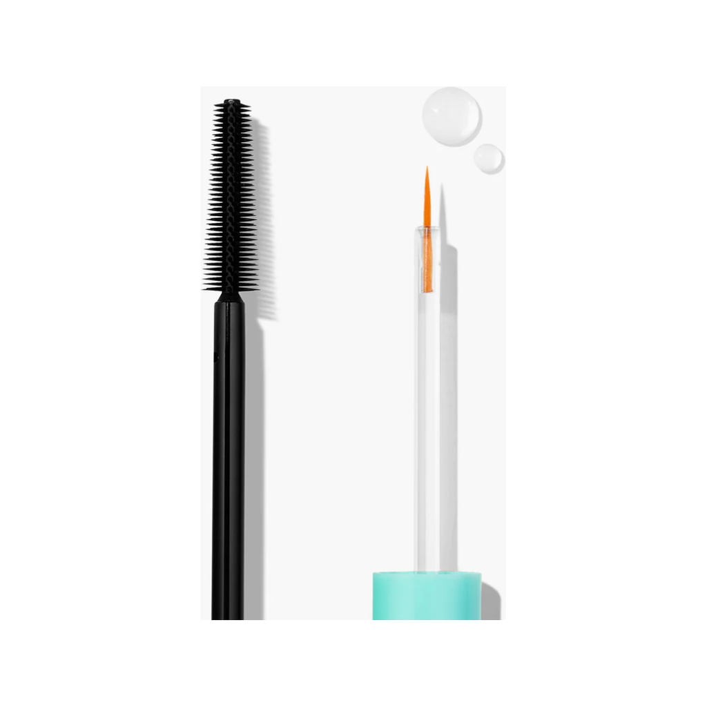 Black mascara wand and an eyeliner pencil with an orange tip against a white background.
