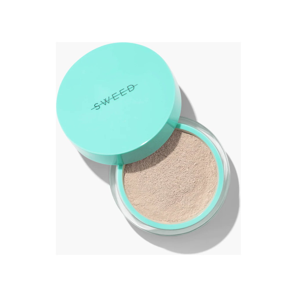A compact cushion foundation with an open lid, showing the sponge applicator and product.