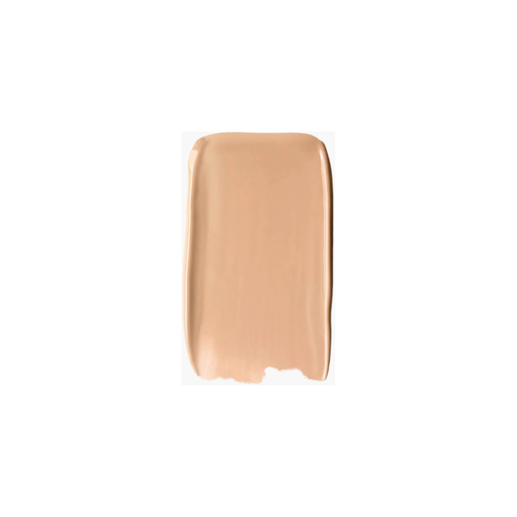 Swatch of beige liquid foundation makeup on a white background.