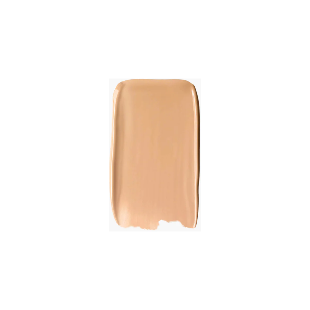 A swatch of beige foundation makeup spread on a surface.