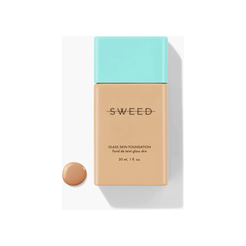 A bottle of sweed glass skin foundation with a sample dab of the product beside it.