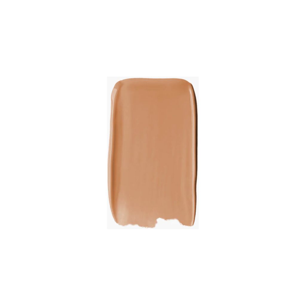 A swatch of beige foundation makeup on a plain background.