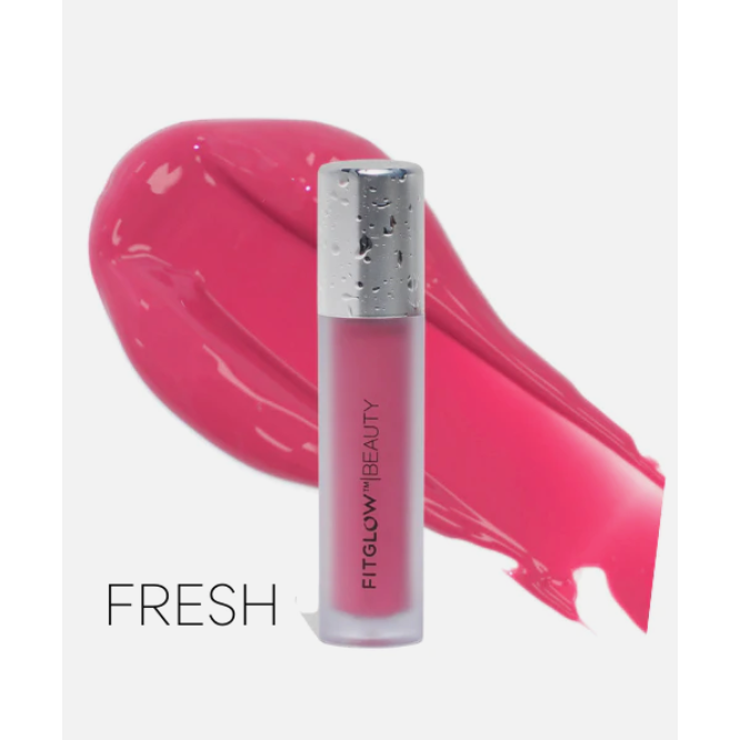 A tube of pink lip gloss with a sample smear of its color.