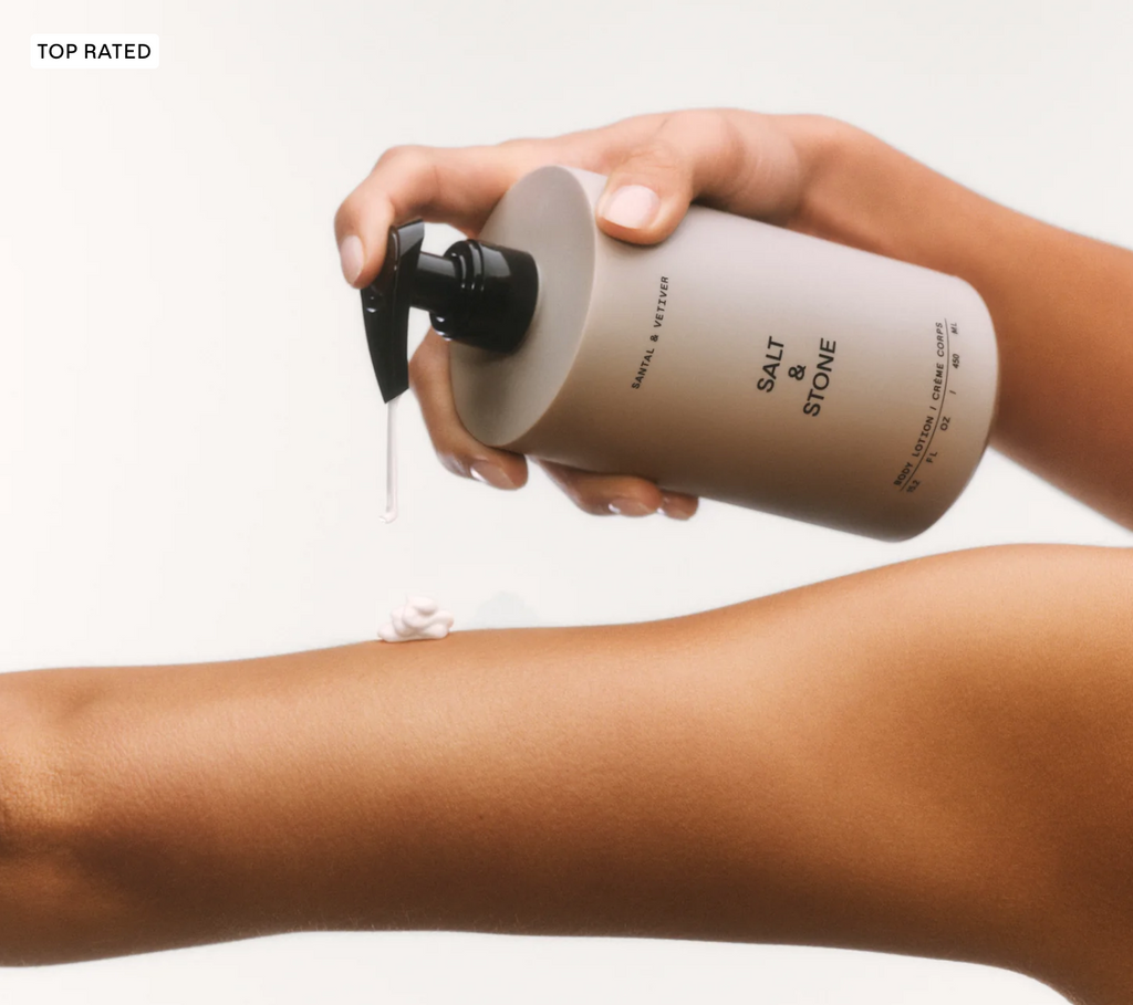 Person applying a product from a 'Salt & Stone' bottle to their arm on a white background