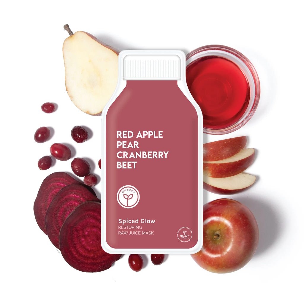 Bottle of red apple, pear, cranberry, and beet juice surrounded by fresh ingredients.