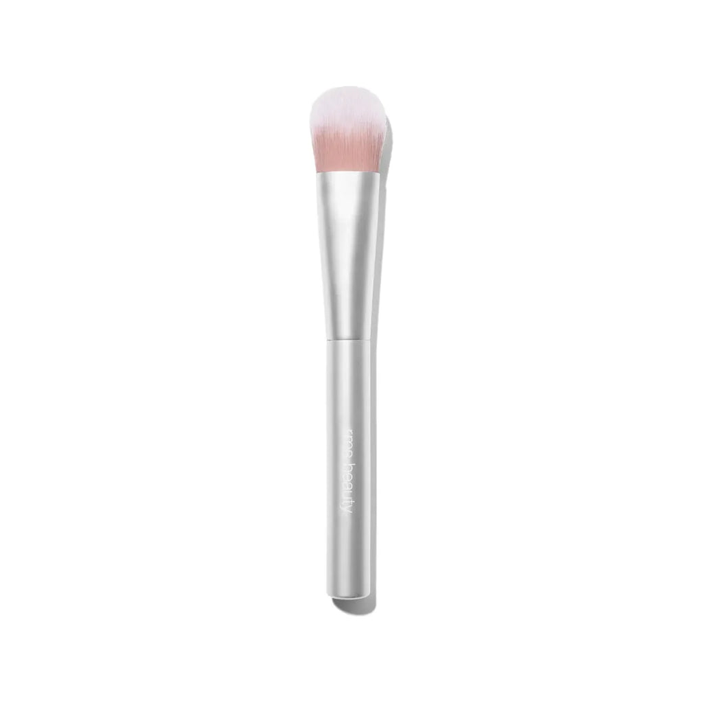 Makeup brush with a silver handle and pink bristles against a white background.
