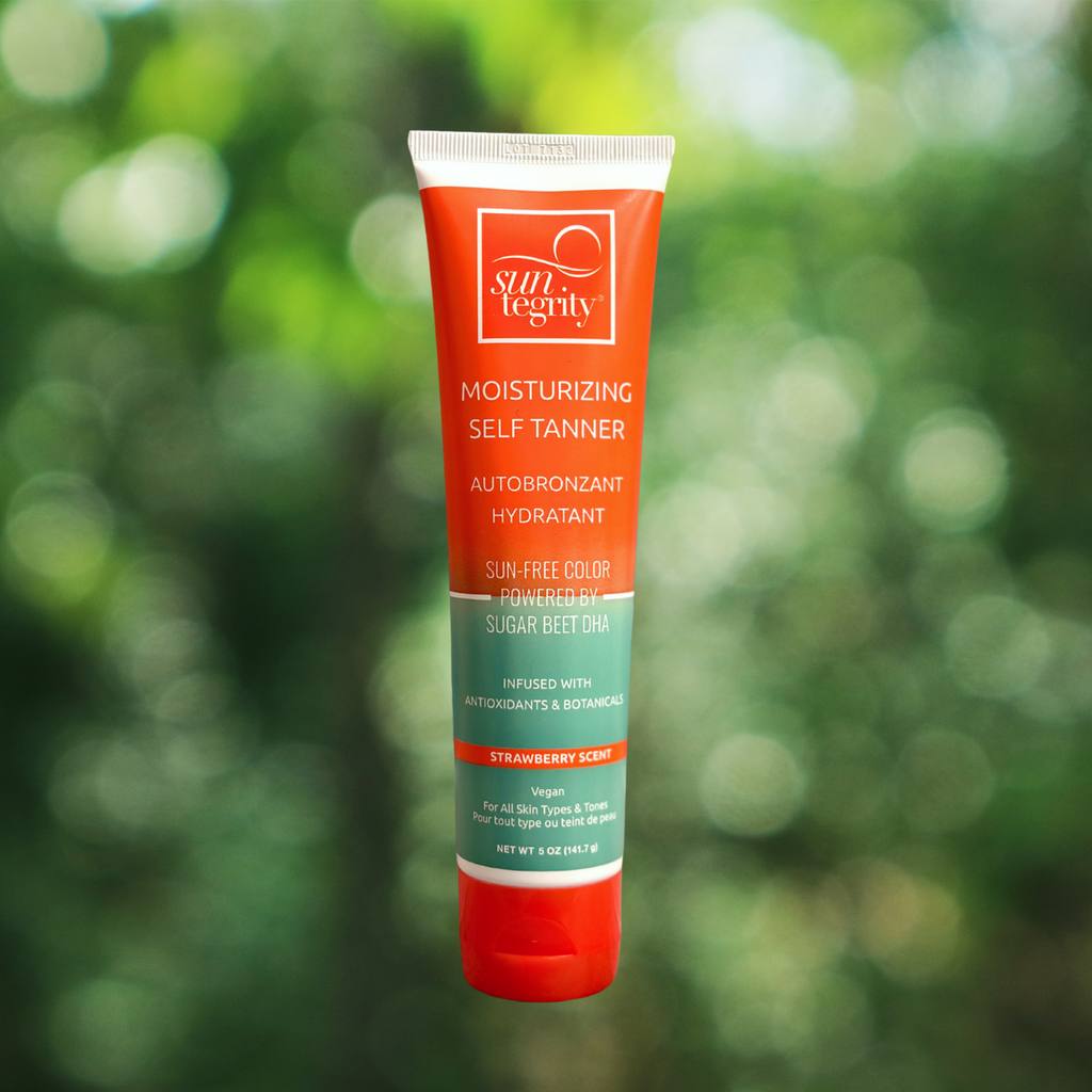 A tube of suntegrity moisturizing self-tanner against a blurred green background.