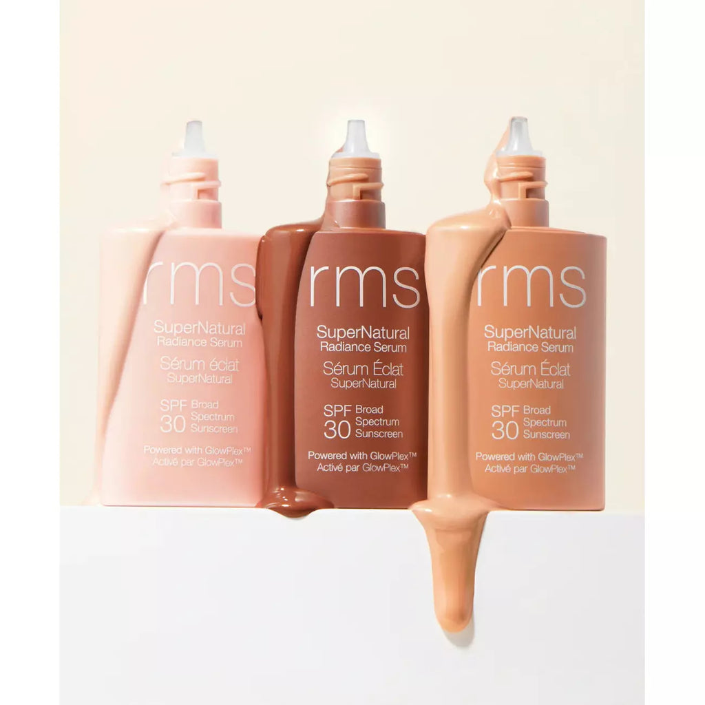 Three bottles of rms beauty sunscreen serum with product squeezed out in front, indicating different shades.