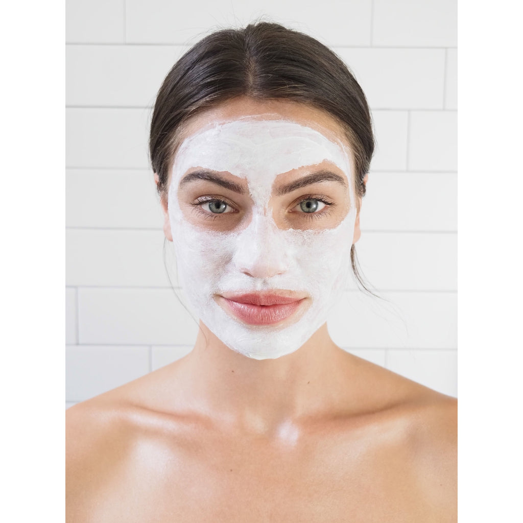 Woman with a facial mask in a spa setting.