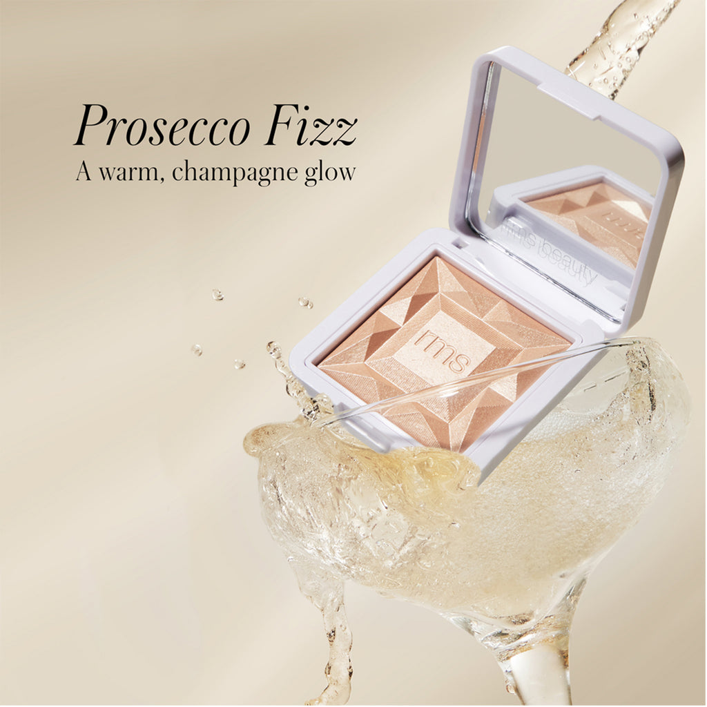 Luxury makeup highlighter with champagne-inspired theme and splash.