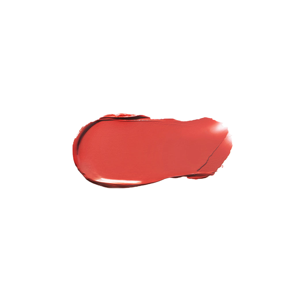A smear of red lipstick on a white background.