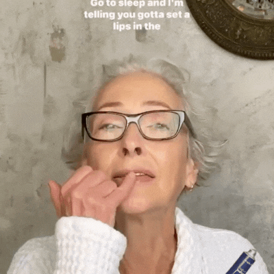 A woman with glasses touching her lips while looking upwards, text overlaid on the image.