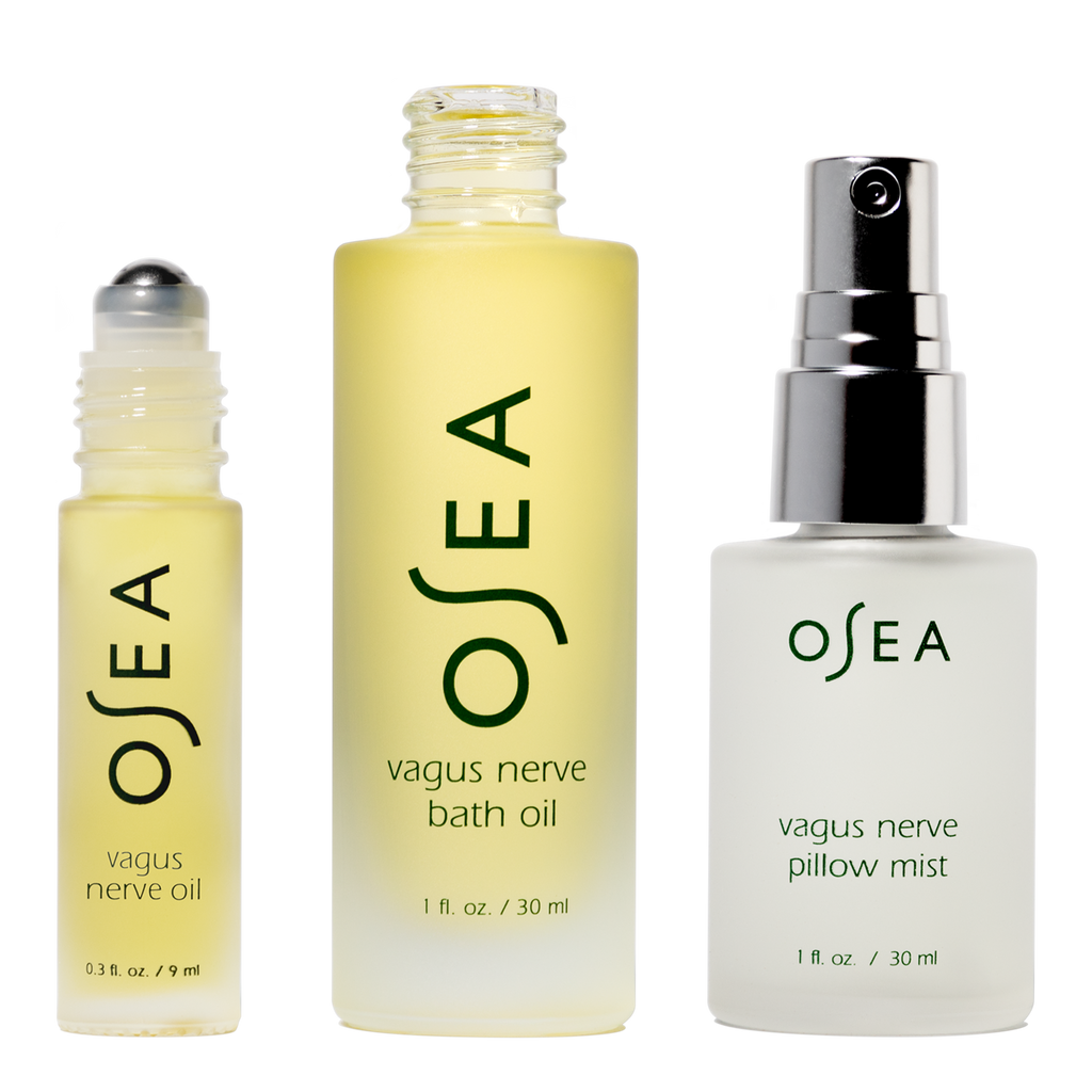Three OSEA products including a roller bottle, bath oil, and pillow mist on a white background.