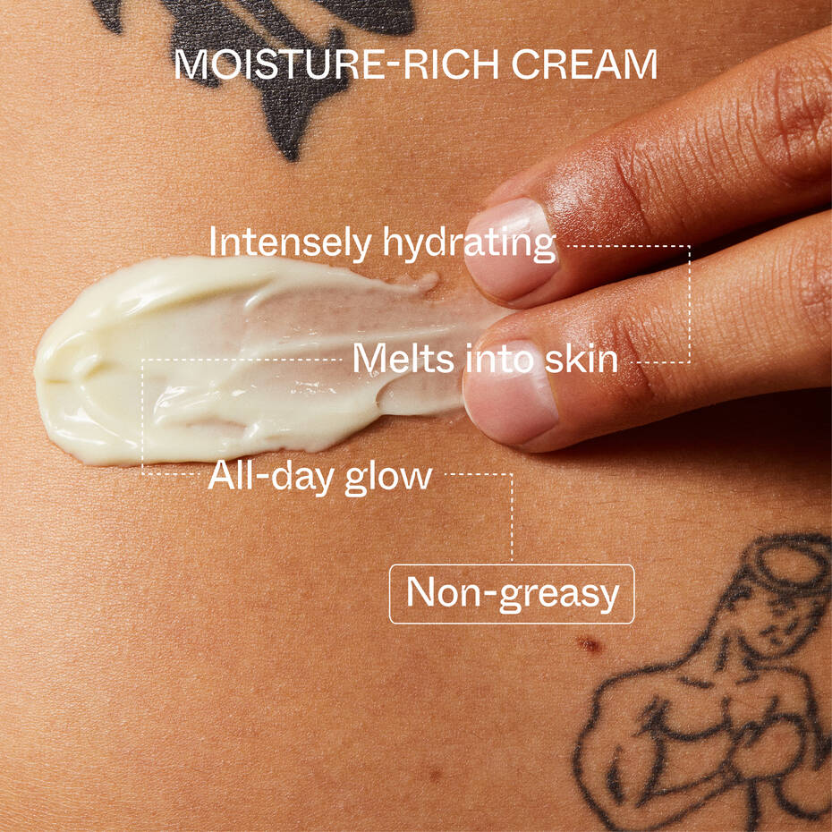Close-up of a hand applying a dollop of Youth To The People Superberry Firm + Glow Dream Body Butter on tanned skin, with promotional text describing the cream's hydrating and non-greasy properties.