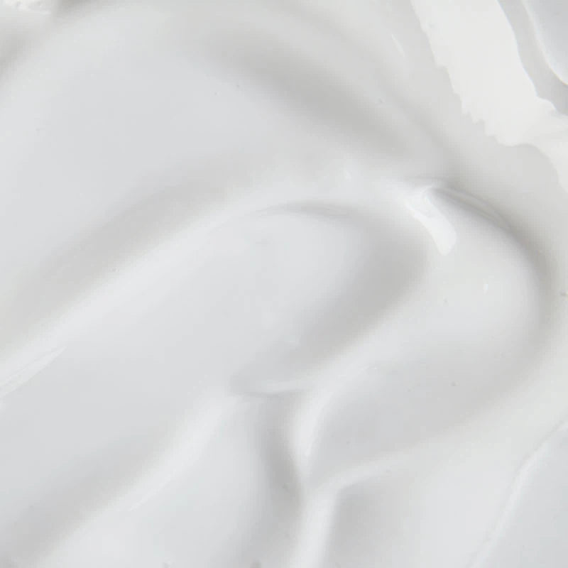 Close-up of a smooth, white creamy substance with subtle ripples.