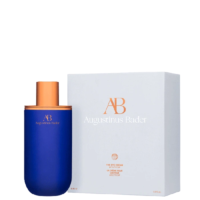 A bottle of augustinus bader skincare cream next to its packaging box.