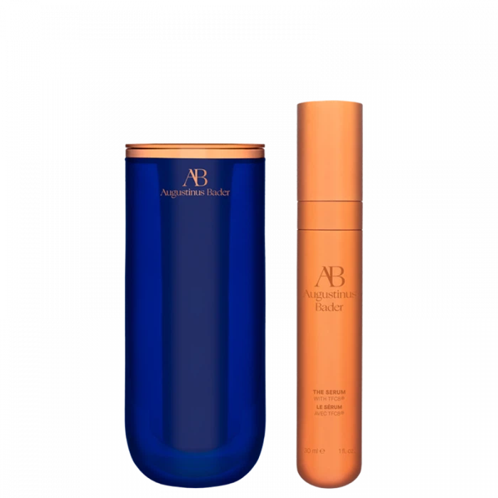 Two skincare products by augustinus bader: a blue moisturizer container and an orange serum bottle.