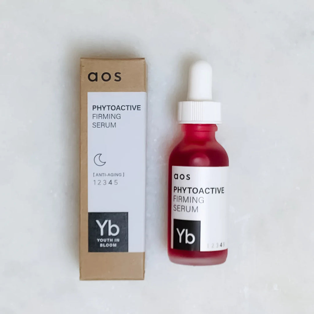 A bottle of phytoactive firming serum next to its packaging.