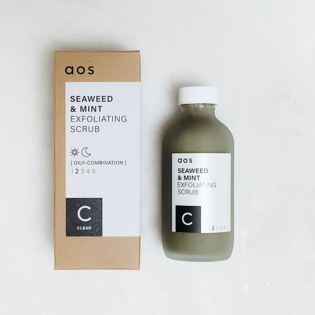 A bottle of seaweed and mint exfoliating scrub next to its packaging.