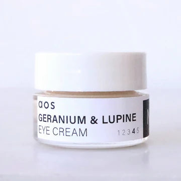 Jar of geranium & lupine eye cream on a plain background.