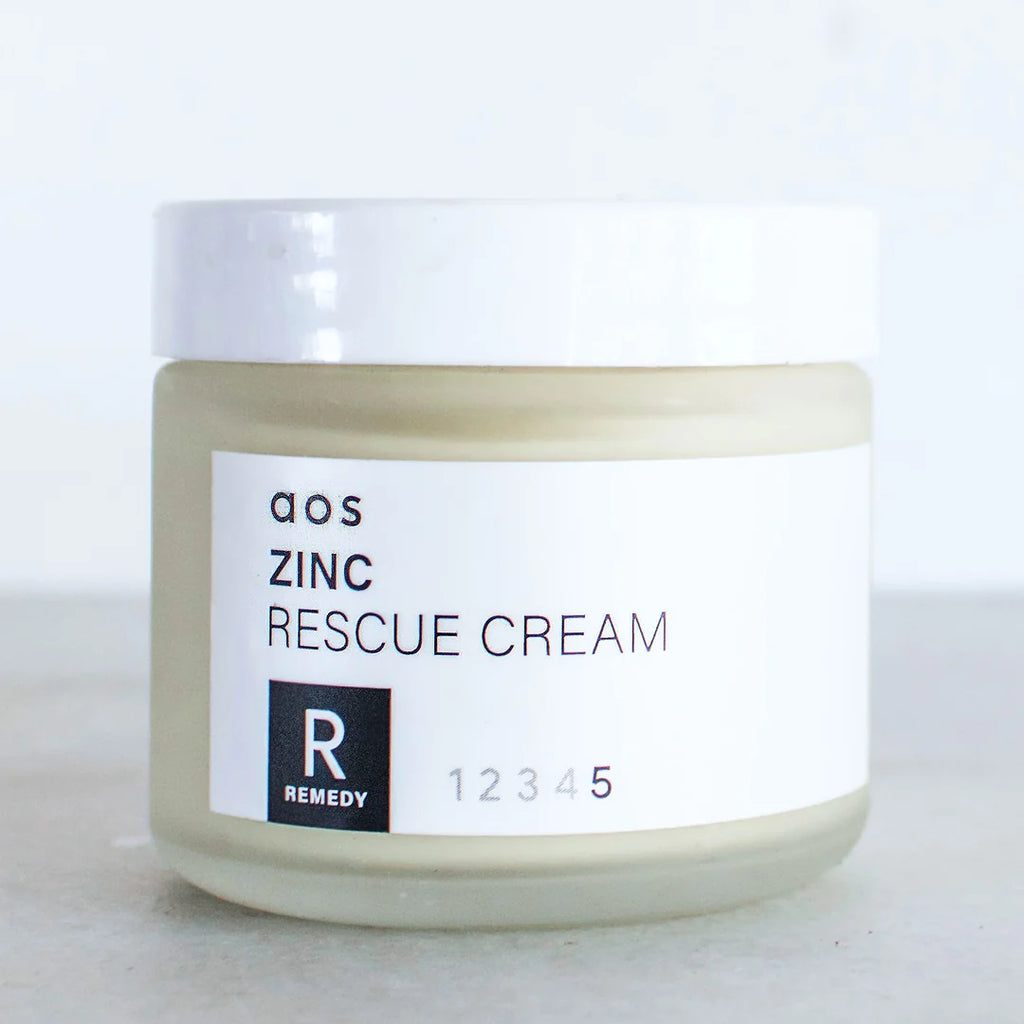 A jar of zinc rescue cream with a label.
