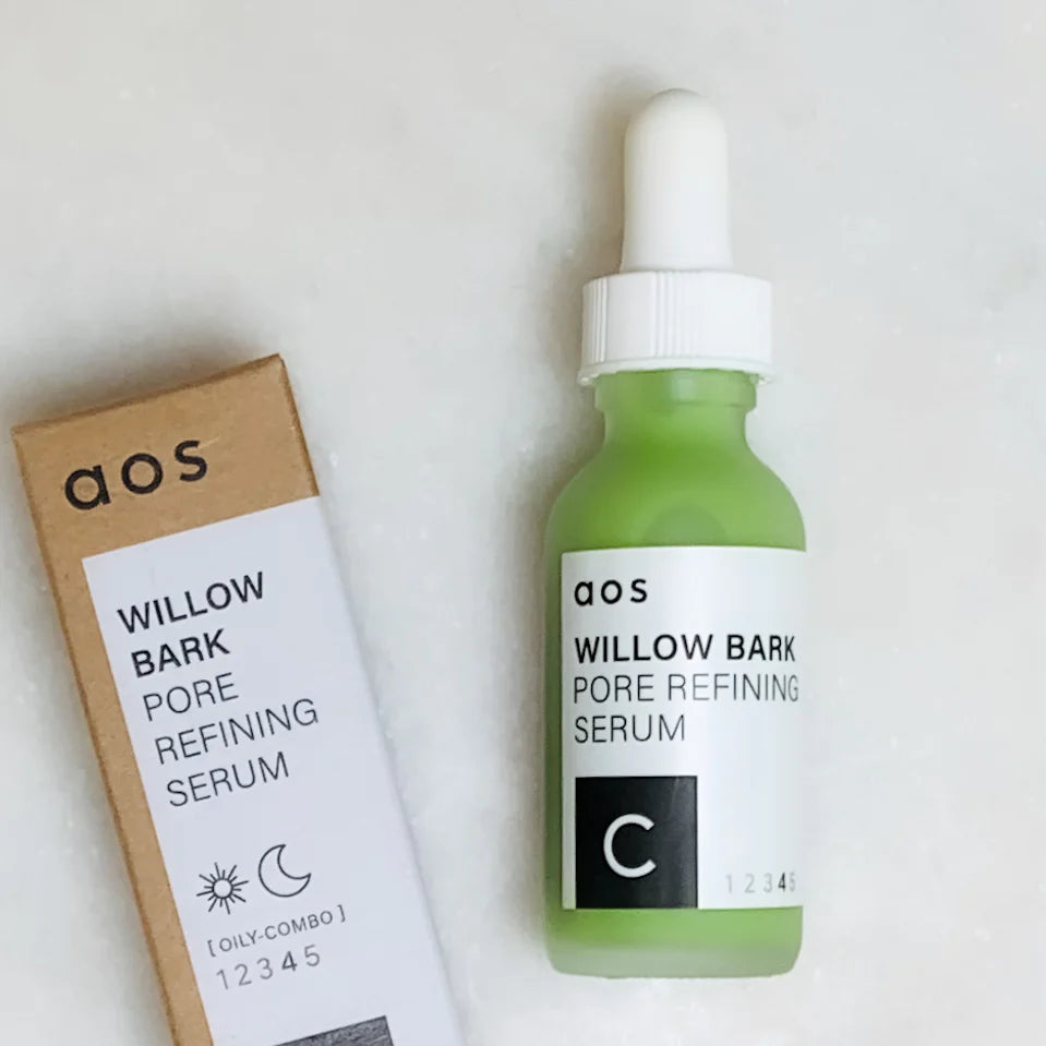 A bottle of willow bark pore refining serum next to its packaging.