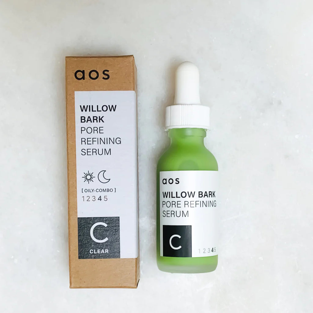 A bottle of willow bark pore refining serum next to its packaging.