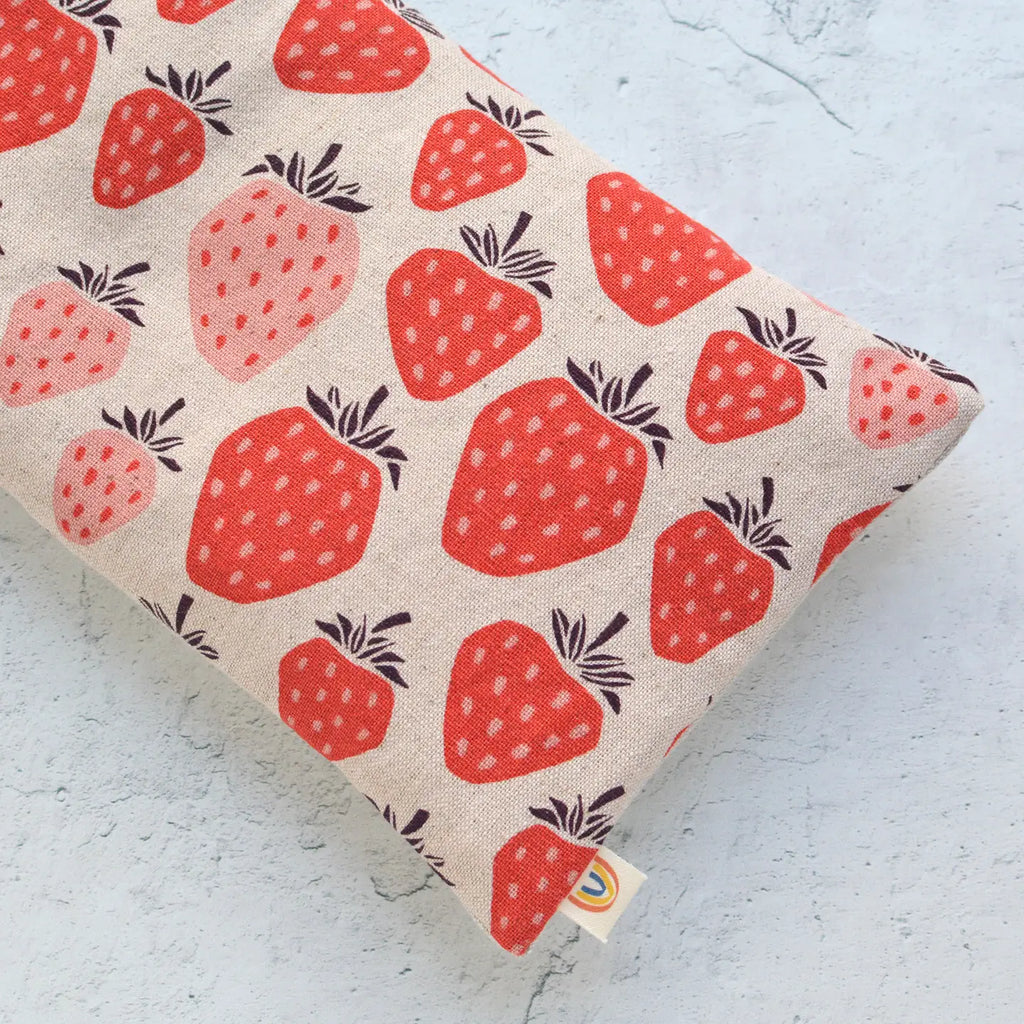 Fabric with strawberry pattern on textured surface.