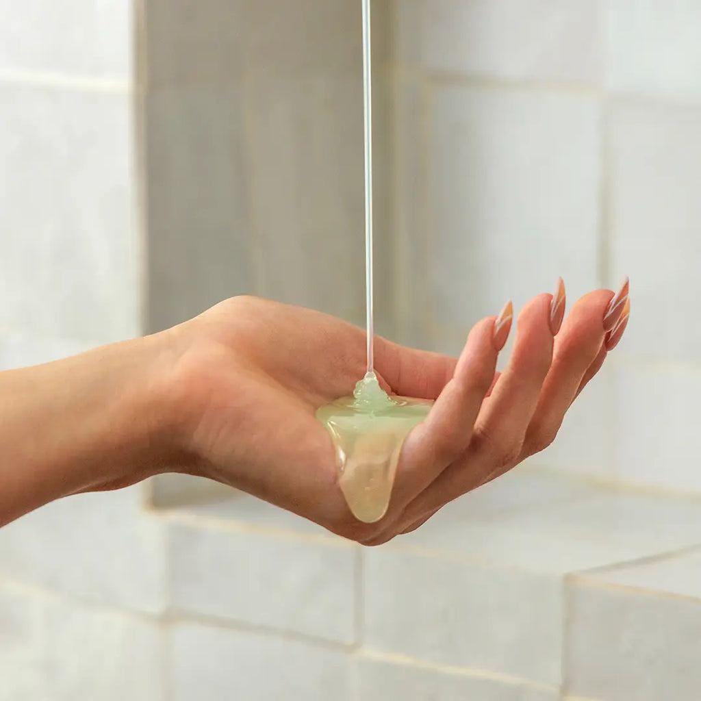 Liquid soap being poured onto an open hand.
