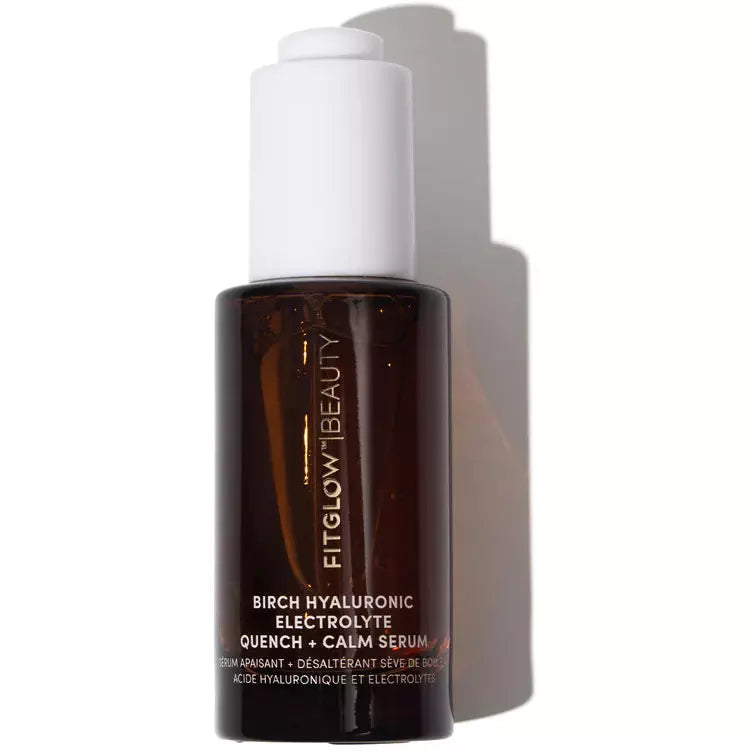 A bottle of fitglow beauty birch hyaluronic electrolyte serum against a light background.